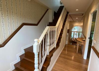 Elegant hallway with wooden staircase and hardwood floors