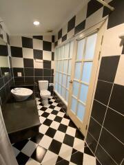 Black and white tiled bathroom with large windows