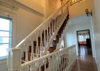 Elegant wooden staircase with white balusters and warm lighting