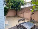 Cozy outdoor patio with seating area and greenery