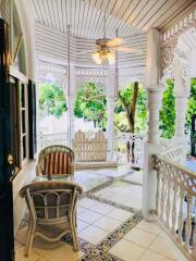 Cozy porch area with seating and garden view