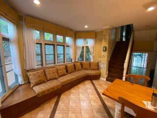 Cozy living room with sectional sofa and staircase