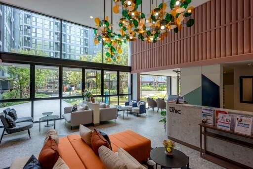 Spacious modern lobby interior with comfortable seating and colorful lighting