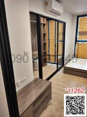 Modern bedroom with large glass door wardrobe and air conditioner