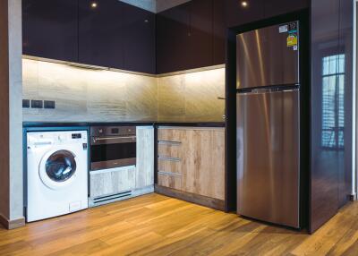 Modern kitchen with stainless steel appliances and wooden accents