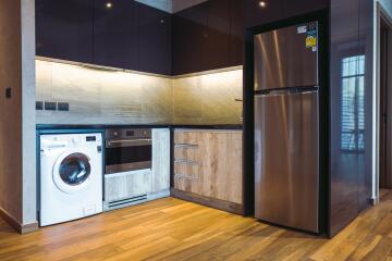 Modern kitchen with stainless steel appliances and wooden accents