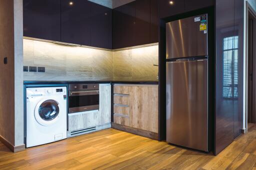 Modern kitchen with stainless steel appliances and wooden accents