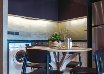 Modern kitchen with integrated appliances and wooden dining table