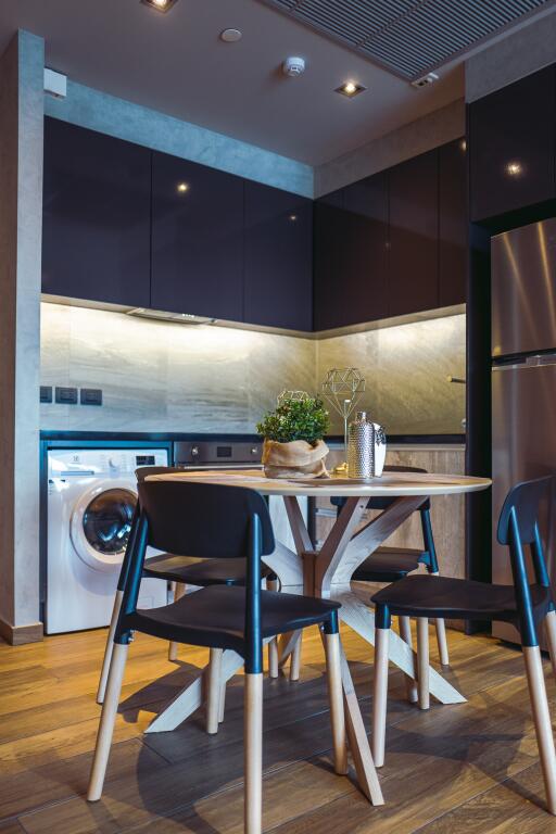 Modern kitchen with integrated appliances and wooden dining table