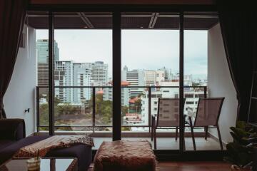 Spacious balcony with city view, comfortable seating and large sliding glass doors