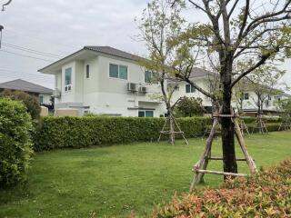 Suburban home with a green lawn and garden