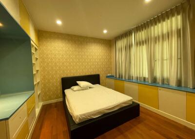 Cozy bedroom with stylish decor and hardwood flooring