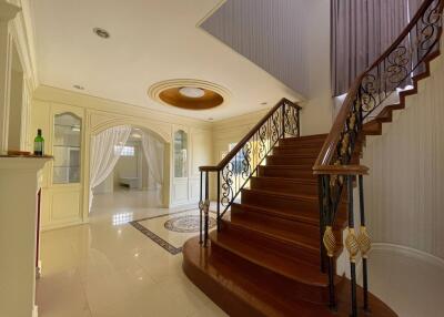 Elegant entryway with staircase and arched doorway