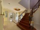 Elegant entryway with staircase and arched doorway