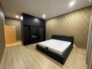 Modern bedroom with large bed and built-in wardrobe