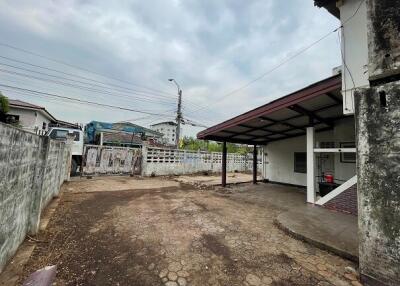 Spacious outdoor area with carport and adjacent open land
