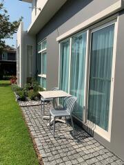 Cozy outdoor patio area with seating arrangement and garden