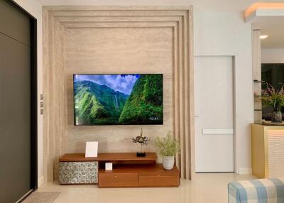 Modern living room with mounted television and decorative plants
