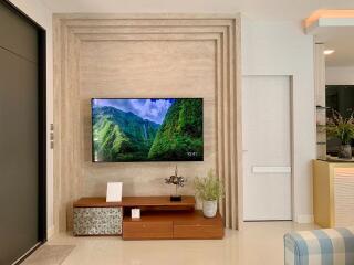 Modern living room with mounted television and decorative plants