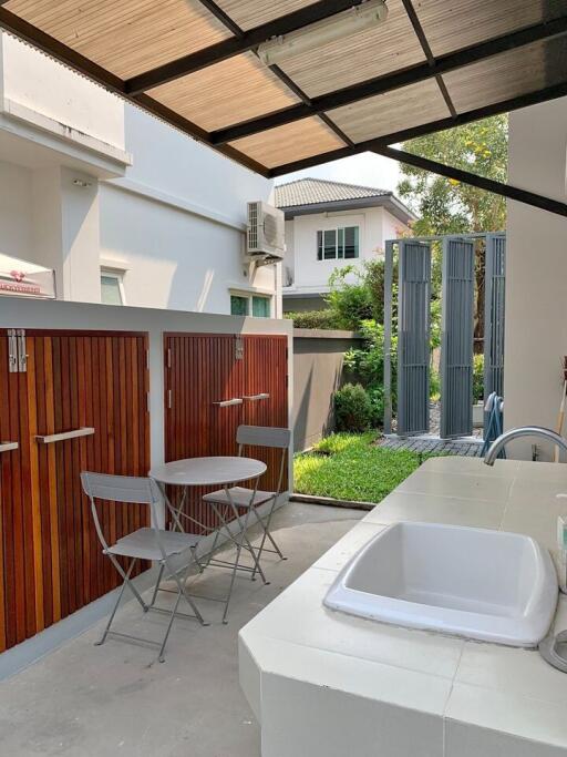 Cozy outdoor patio area with seating and integrated sink