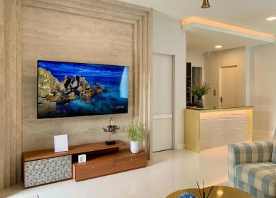 Modern living room with large flat-screen TV and stylish interior design
