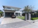 Modern two-story house with spacious driveway and garage