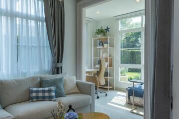 Bright and cozy living room with large windows and comfortable seating