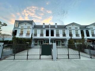 Elegant multi-story residential building exterior at dusk