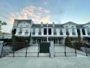 Elegant multi-story residential building exterior at dusk