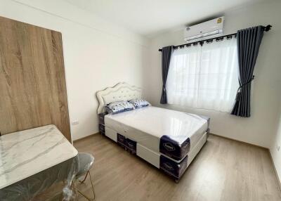 Bright and modernly furnished bedroom with air conditioning