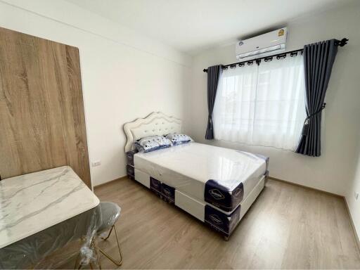 Bright and modernly furnished bedroom with air conditioning