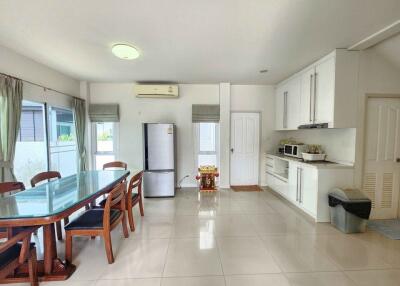 Spacious kitchen with dedicated dining area, modern amenities, and tiled flooring