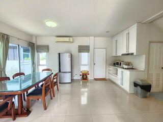 Spacious kitchen with dedicated dining area, modern amenities, and tiled flooring