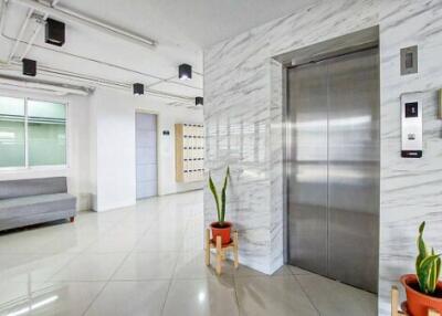 Spacious and modern building lobby with marble tiles and comfortable seating