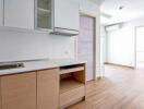 Bright and modern kitchen with wooden cabinets and white interiors