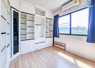 Bright and modern bedroom with built-in wardrobes and air conditioning unit