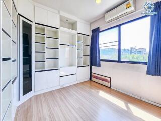 Bright and modern bedroom with built-in wardrobes and air conditioning unit