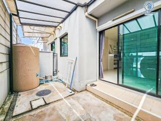 Backyard patio area with glass doors leading into the interior