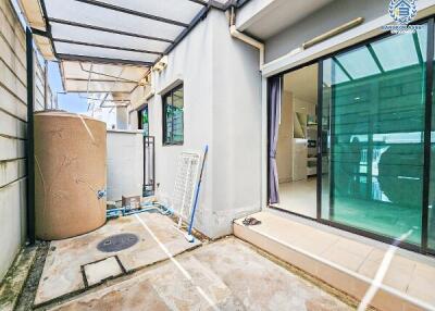 Backyard patio area with glass doors leading into the interior
