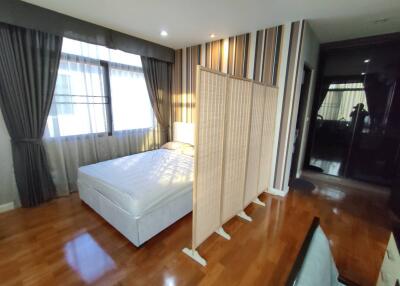 Spacious bedroom with ample natural light and hardwood floors