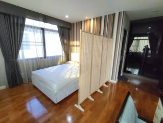 Spacious bedroom with ample natural light and hardwood floors