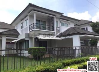 Two-story suburban house with a lawn and clear skies