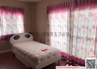 Cozy bedroom with a single bed and floral curtains
