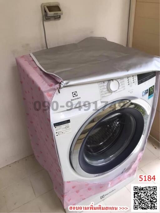 A modern washing machine in a compact laundry space