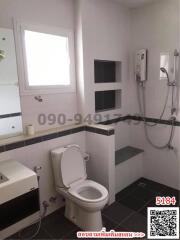 Modern bathroom with white fixtures and tiled flooring