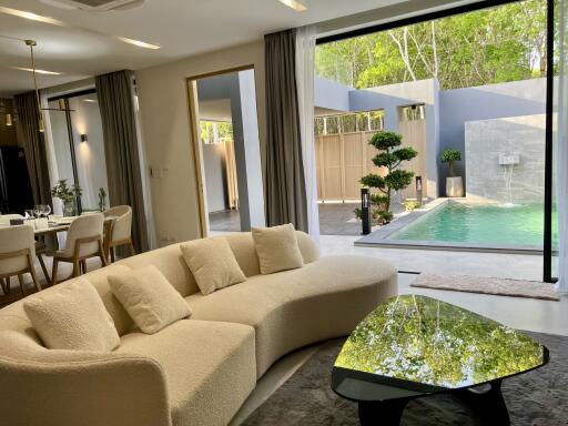 Spacious living room with direct access to the pool area