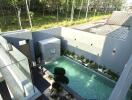 Elevated view of a modern house with a private pool and garden