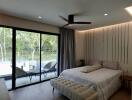 Spacious bedroom with large windows and natural surroundings