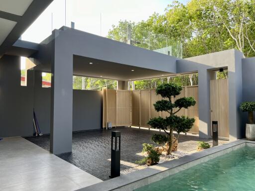 Modern home exterior with swimming pool and carport