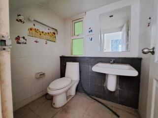 Spacious bathroom with white fixtures and natural light